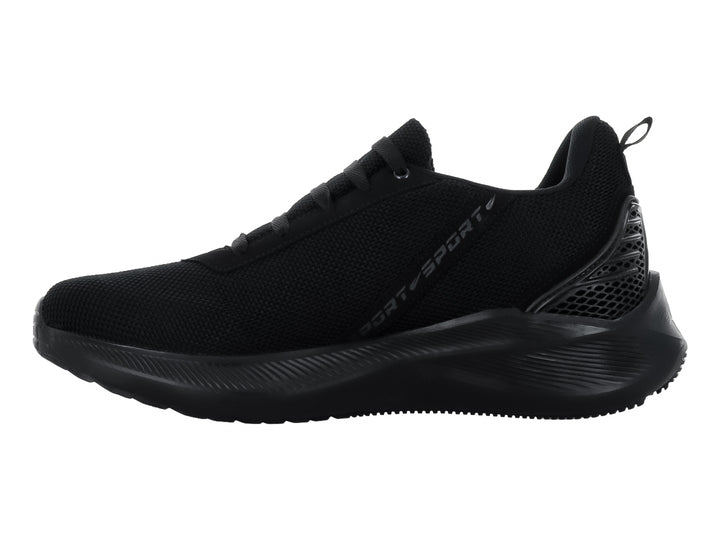 Tenis deportivo color negro con tejido de malla y suela gruesa.