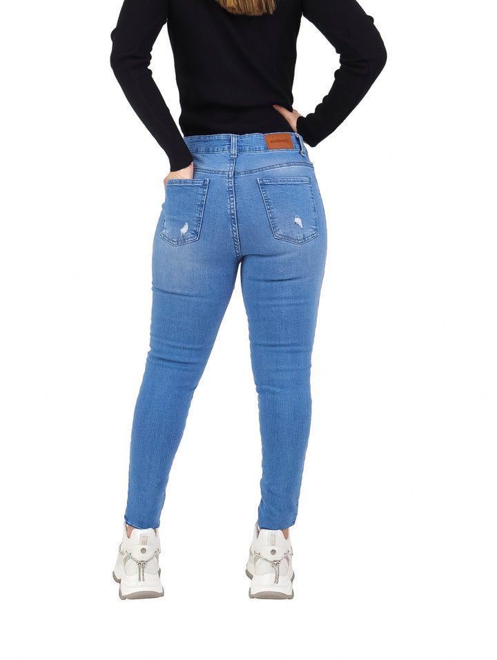 Jeans skinny color azul bleach con detalles de destrucción para mujer.