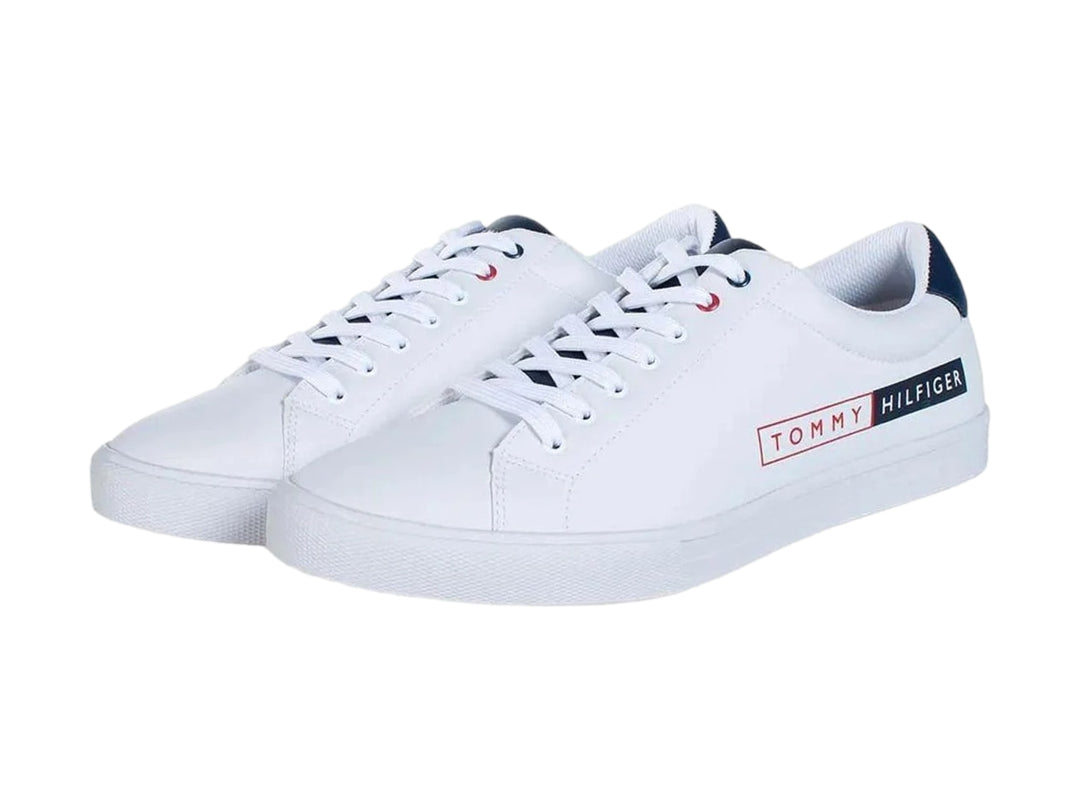 Tenis Tommy Hilfiger color blanco con detalles en azul y logotipo rectangular en el costado.