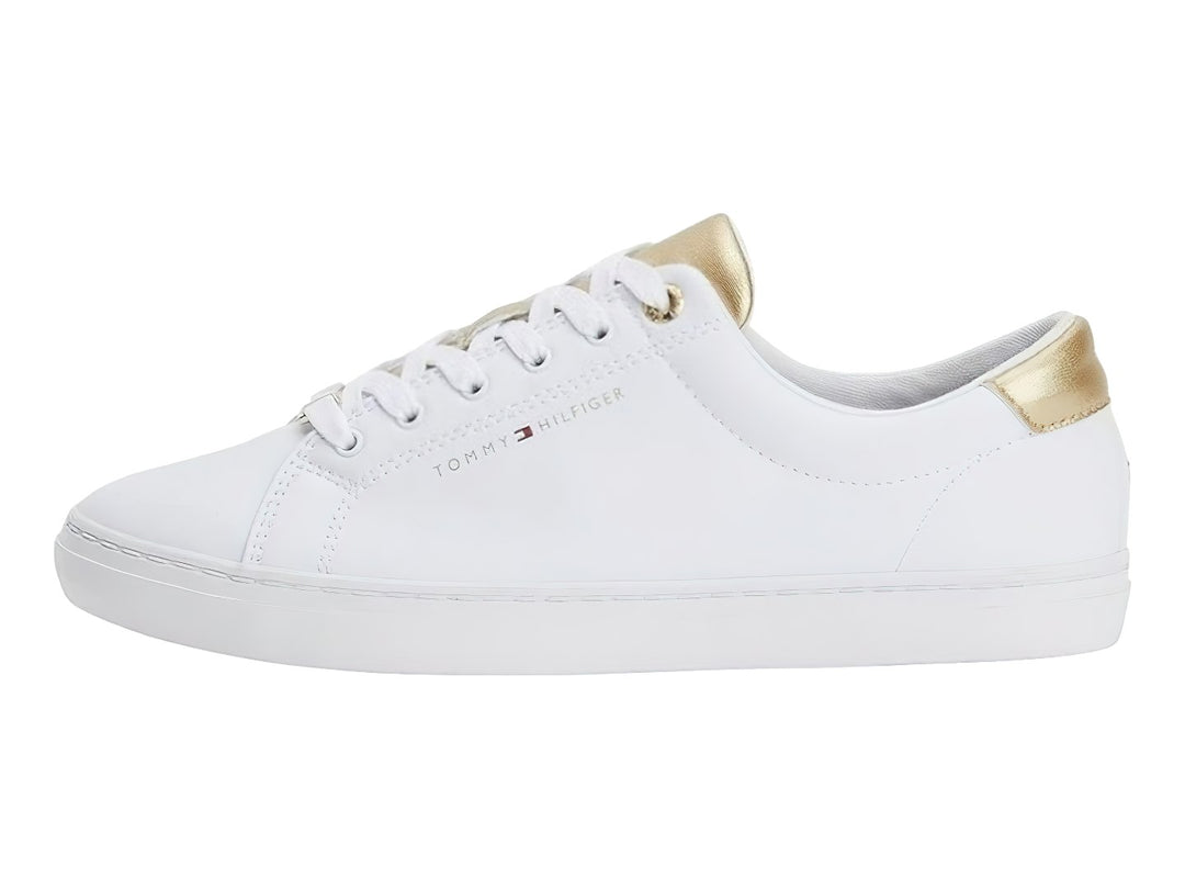Tenis blancos de Tommy Hilfiger con detalles dorados en el talón y la lengüeta.