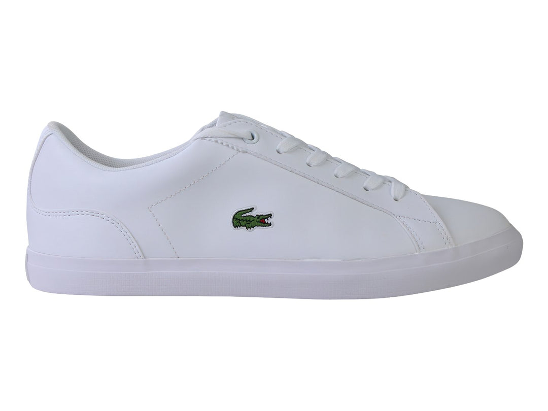 Tenis Lacoste blancos de cuero para niño con suela plana y logotipo del cocodrilo en el lateral.