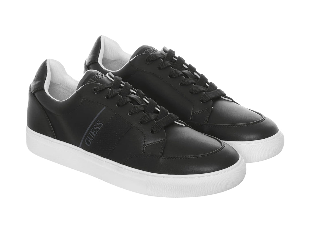 Tenis Guess color negro con suela blanca y diseño casual de corte bajo.