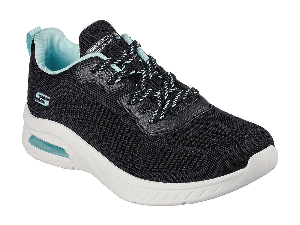 Tenis deportivos Skechers color negro con suela blanca y detalles en turquesa.