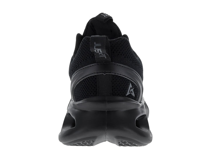 Tenis de baloncesto JUSTART color negro con suela ondulada y diseño futurista.