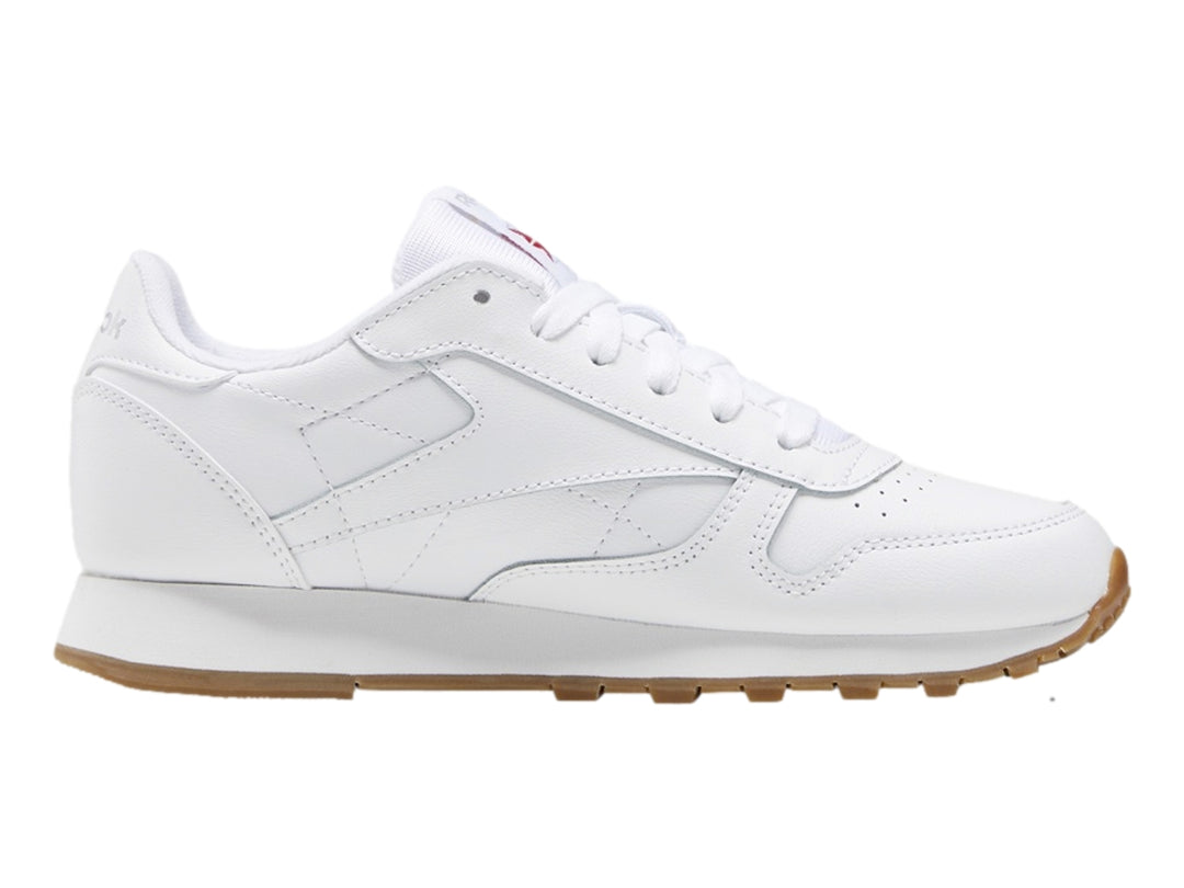 Tenis Reebok blancos de cuero con suela color café para niños pequeños.