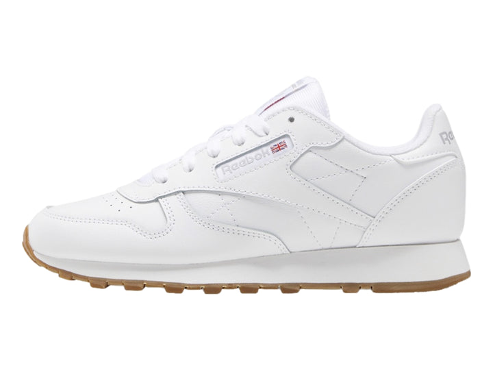 Tenis Reebok blancos de cuero con suela color café para niños pequeños.