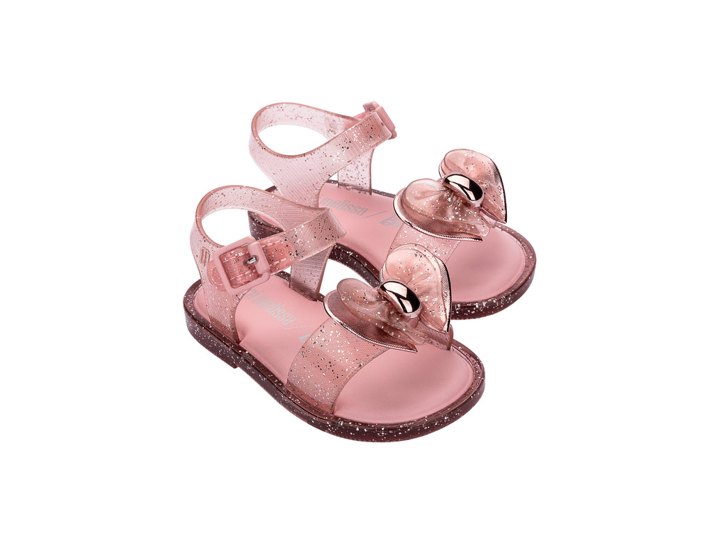 Par de sandalias Mini Melissa color rosa brillante con detalle de moño y correa ajustable para niña.