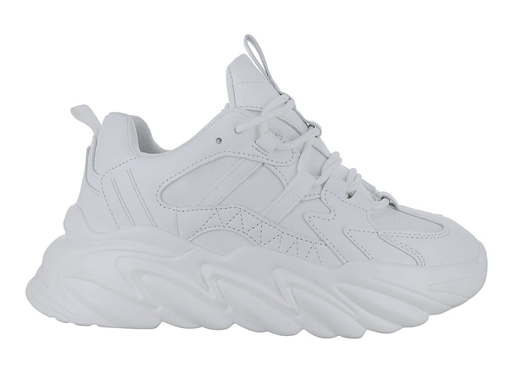 Tenis blancos de plataforma con suela ondulada y diseño moderno.