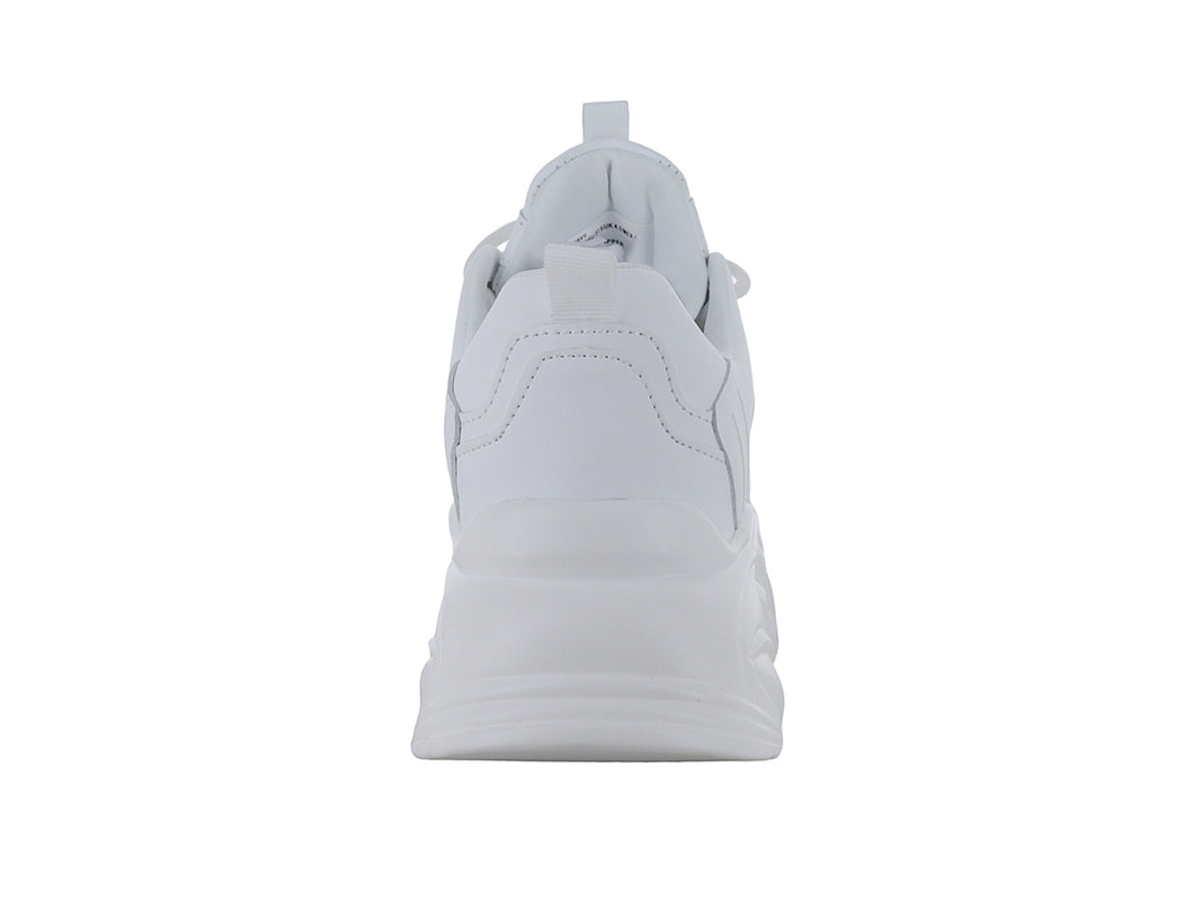 Tenis blancos de plataforma con suela ondulada y diseño moderno.