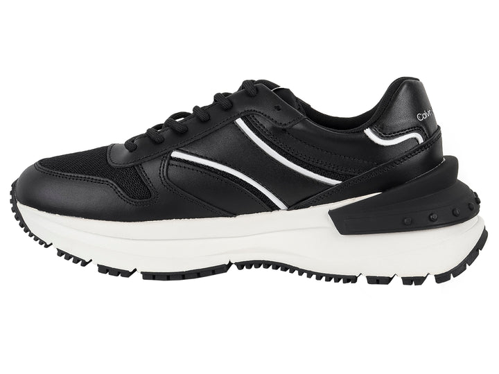 Tenis Calvin Klein Jeans color negro con suela blanca y detalles laterales en blanco.