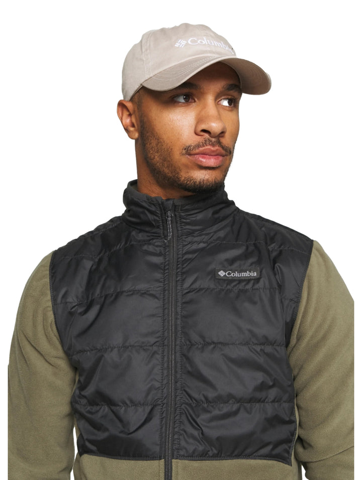 Chaqueta Columbia bicolor verde oliva y negro con panel superior acolchado y cierre frontal.