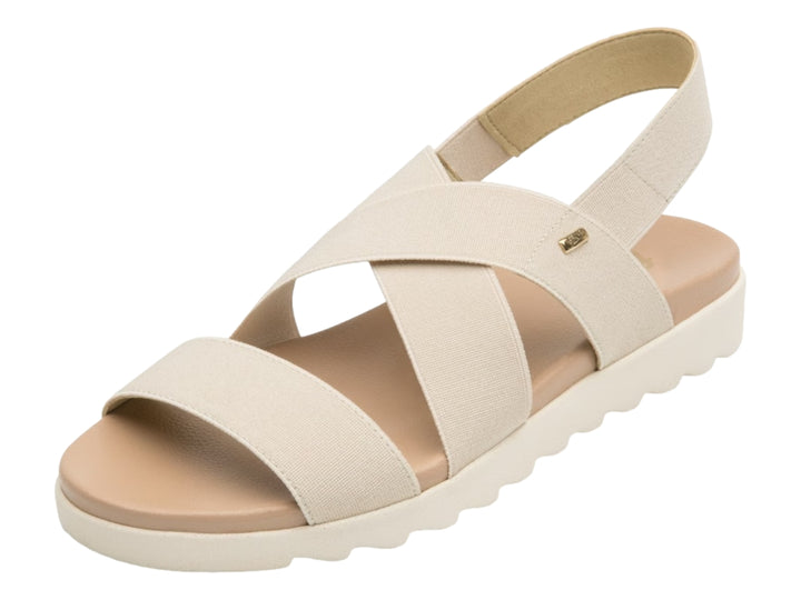 Sandalia Flexi para mujer en color beige con correas textiles cruzadas y suela blanca ondulada.