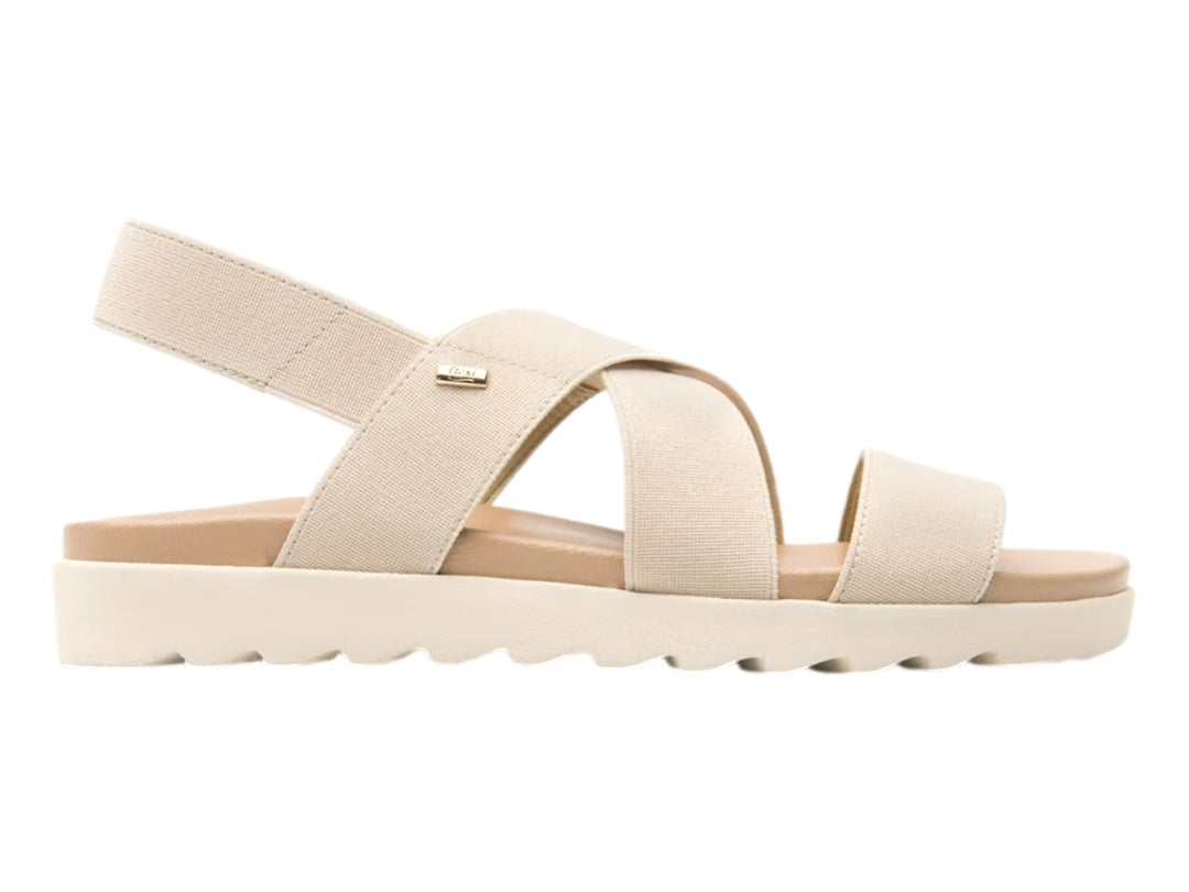 Sandalia Flexi para mujer en color beige con correas textiles cruzadas y suela blanca ondulada.