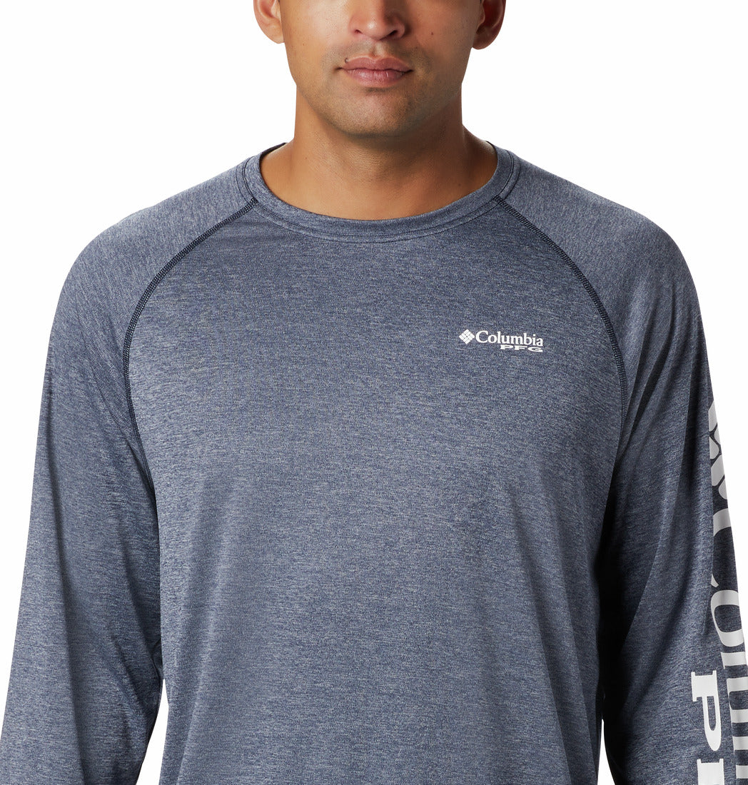 Hombre vistiendo camiseta de manga larga Columbia color azul marino jaspeado con logotipo en la manga.
