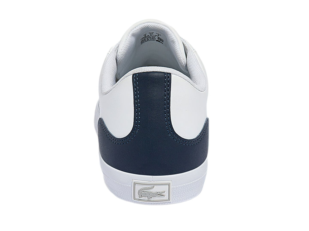 Tenis Lacoste blancos con talón azul marino y logotipo de cocodrilo verde.