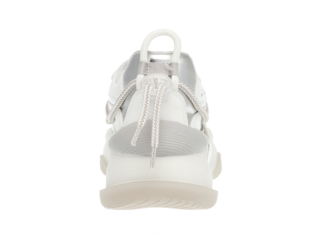 Tenis blancos y plateados Steve Madden con suela gruesa y detalles de malla.