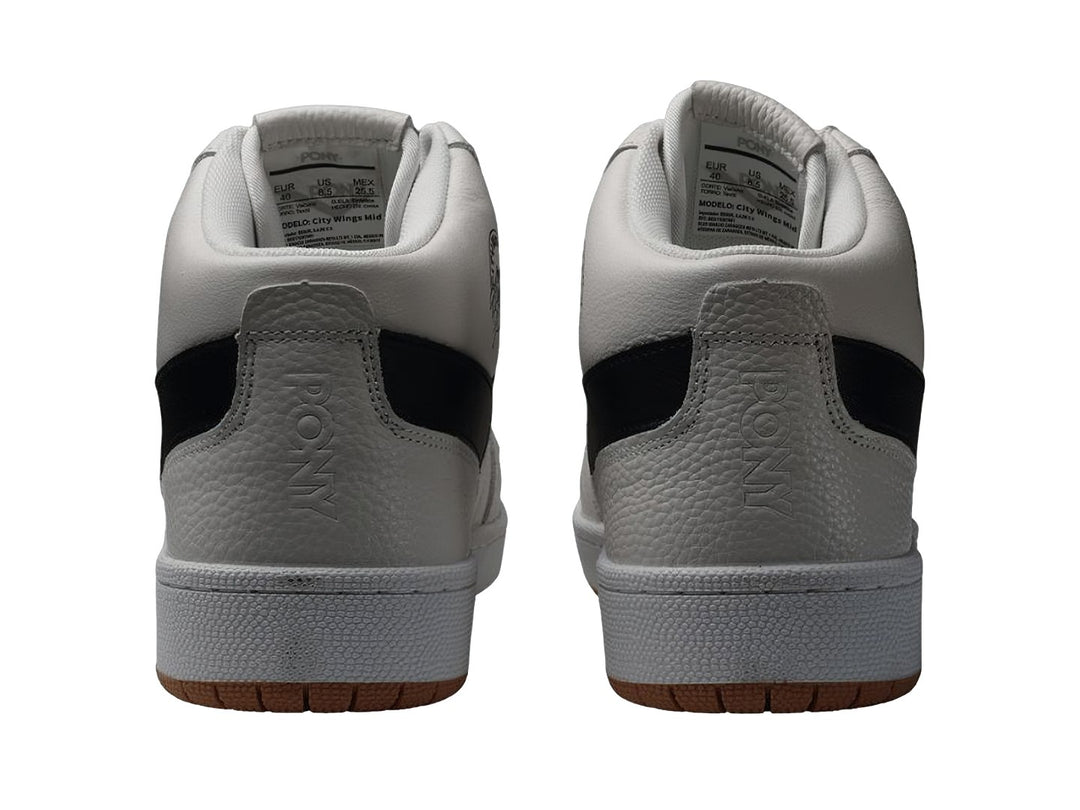 Tenis PONY City Wings Mid color blanco con detalle en negro y suela color caramelo.