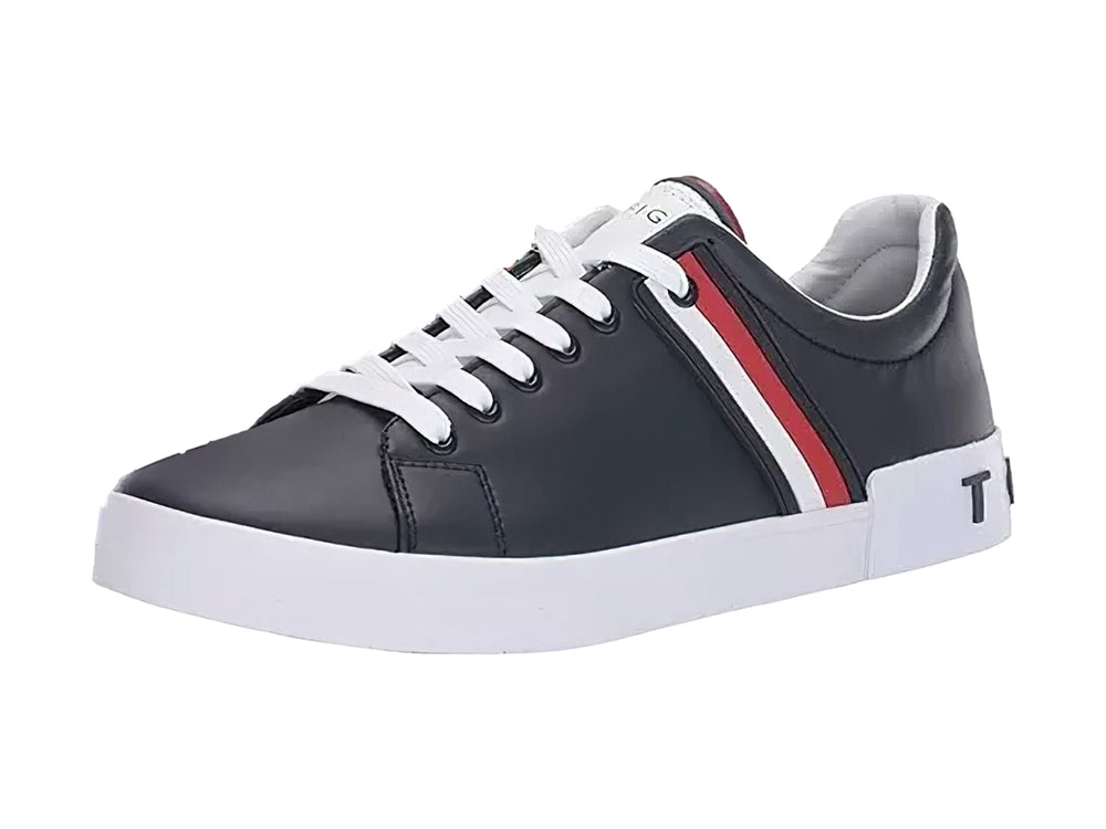Tenis Tommy Hilfiger color negro con suela blanca y detalle de franja roja y blanca lateral.