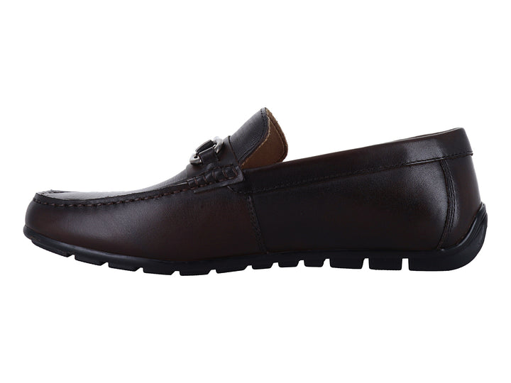 Zapato mocasín de cuero marrón con detalle de herraje metálico plateado en la parte superior.