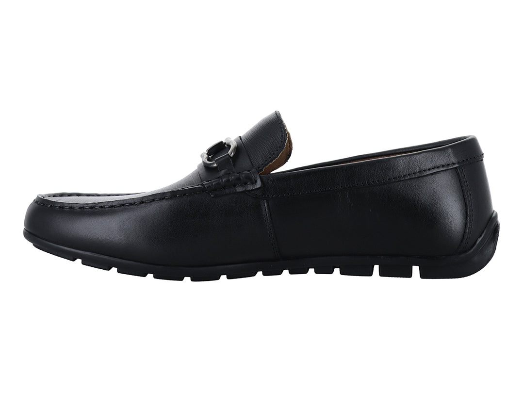 Zapato mocasín de cuero negro con herraje metálico plateado en la parte superior.