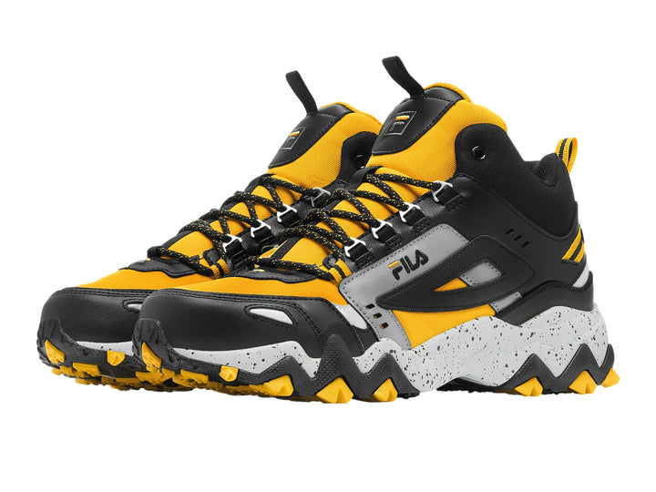 Tenis FILA Oakmont-TR Mid en colores amarillo, negro y gris con suela gruesa y robusta.