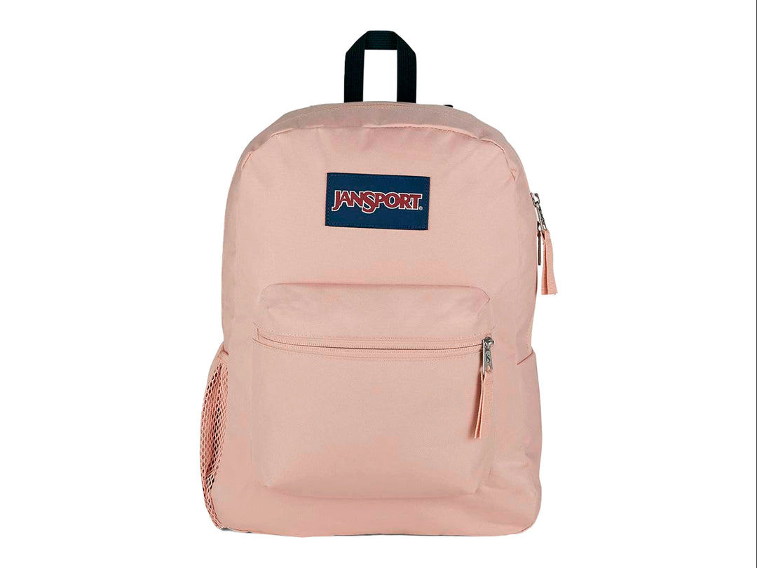 Mochila escolar JanSport color rosa pálido con bolsillo frontal y asa superior negra.