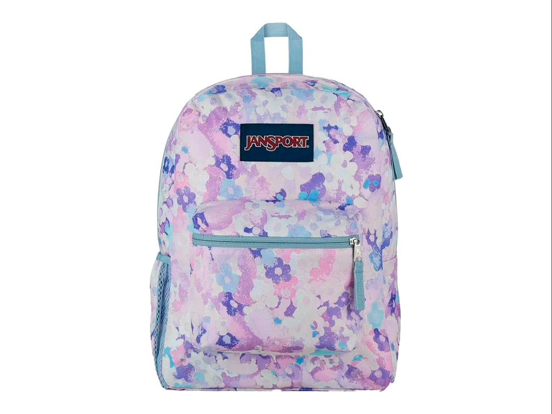 Mochila escolar JanSport con estampado floral en tonos morados, azules y rosas.