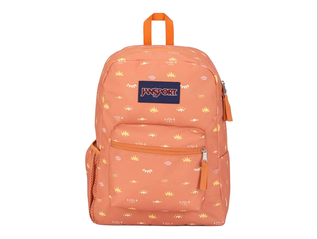 Mochila escolar JanSport color naranja con estampado amarillo de ojos y soles.