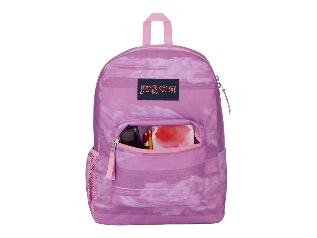 Mochila escolar JanSport color rosa con estampado abstracto y bolsillo frontal.