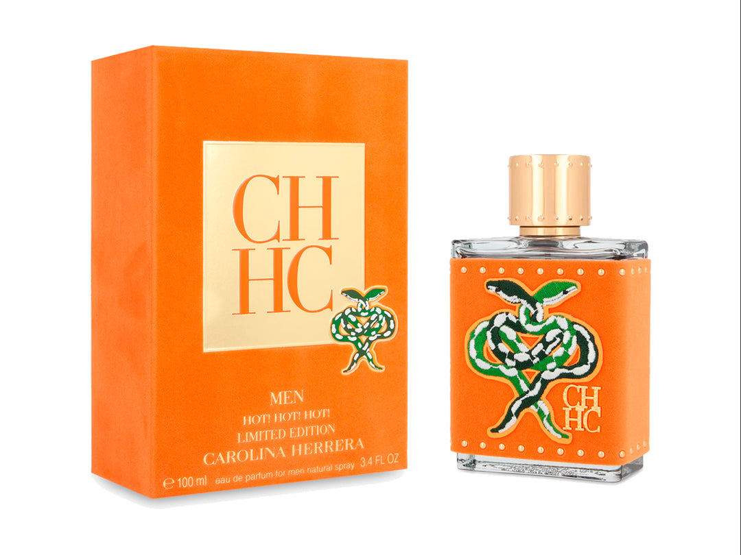 Perfume Carolina Herrera Men Hot Hot Hot Limited Edition en frasco y caja de color naranja con detalles dorados.