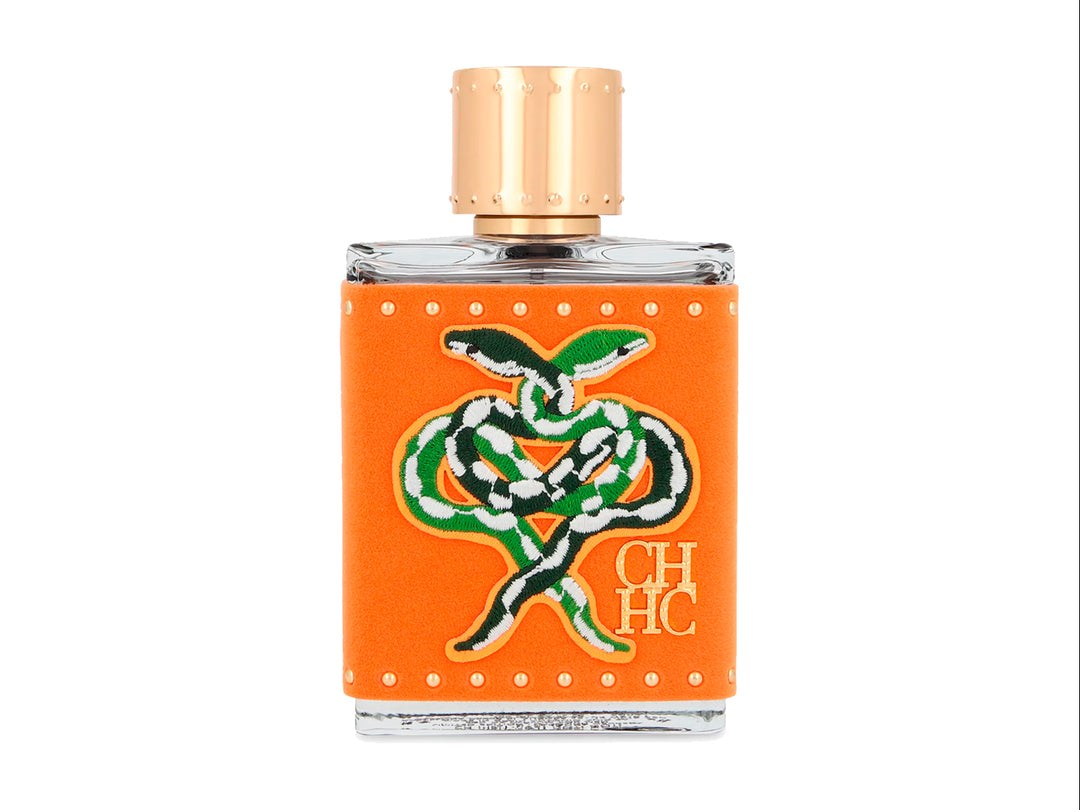 Perfume Carolina Herrera Men Hot Hot Hot Limited Edition en frasco y caja de color naranja con detalles dorados.