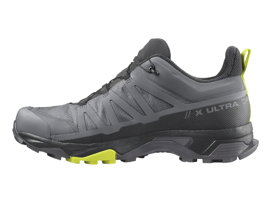 Zapato de senderismo Salomon X Ultra 4 Mid GTX en colores gris y negro con detalles en amarillo neón.