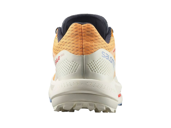 Tenis Salomon Pulsar Trail color amarillo y blanco con detalles rojos y suela blanca robusta.