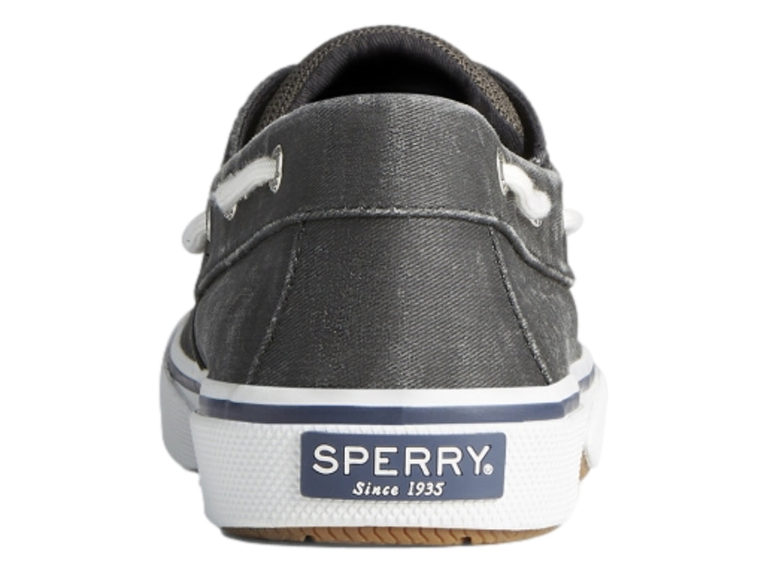 Zapato náutico Sperry de color negro lavado con suela blanca y agujetas blancas.