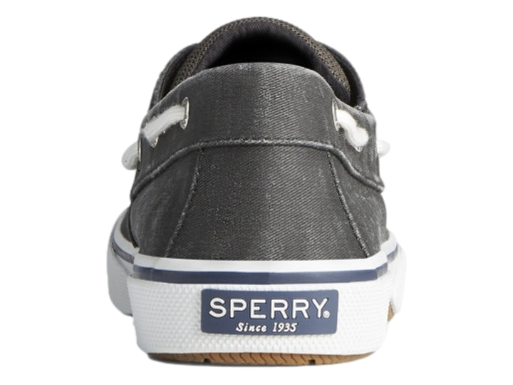 Zapato náutico Sperry de color negro lavado con suela blanca y agujetas blancas.