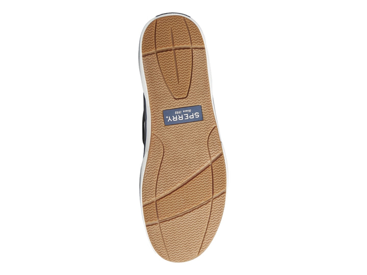 Zapato náutico Sperry de tela azul marino con suela blanca y cordones blancos.