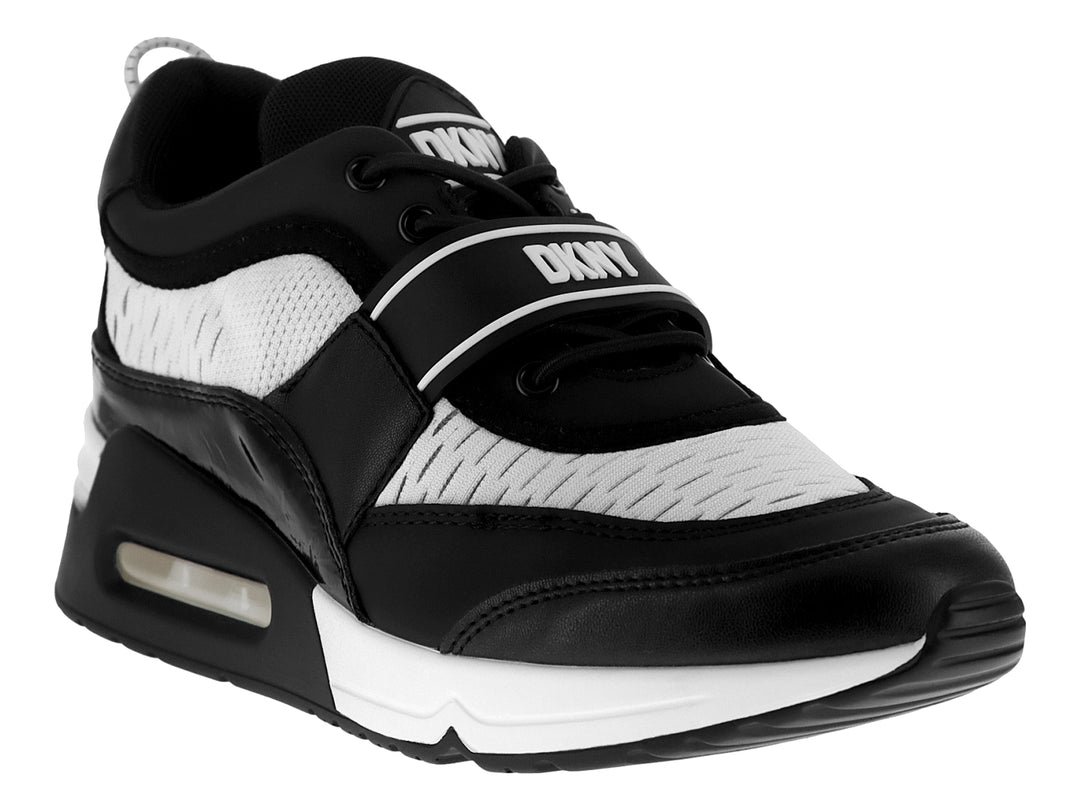Tenis DKNY color blanco y negro con correa ajustable y suela con amortiguación.