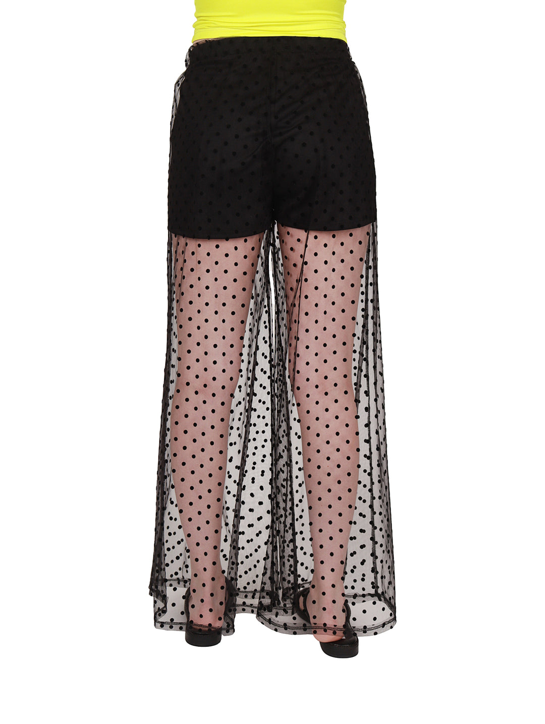 Pantalón negro con sección inferior transparente y estampado de lunares.