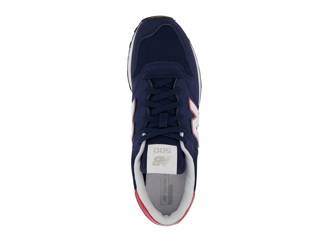 Tenis New Balance color azul marino con detalles en blanco y rojo y suela blanca.