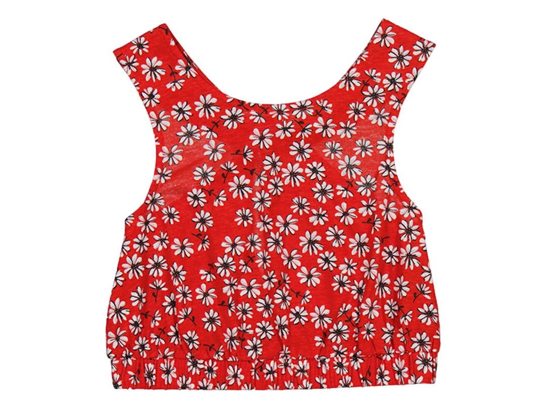 Camiseta roja sin mangas para niña con estampado floral blanco y negro y detalle elástico en la base.