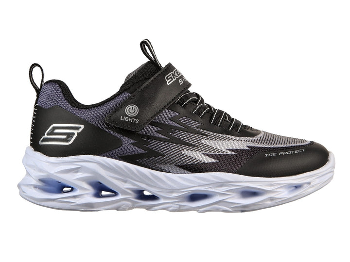 Tenis deportivos Skechers para Niño en color negro y gris con suela blanca gruesa y detalles azules.