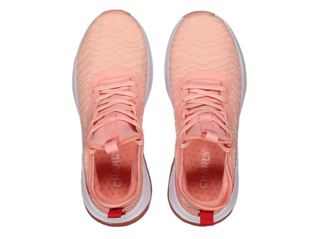 Tenis deportivos Charly en color rosa con suela blanca y cámara de aire visible.
