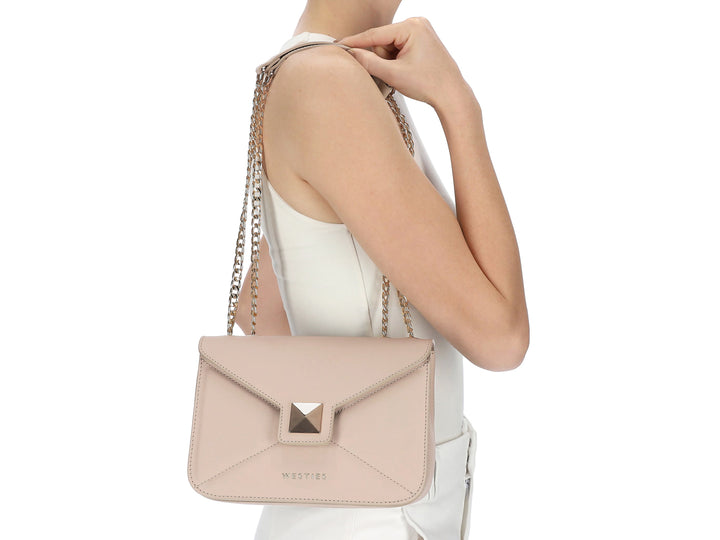 Bolso Nine West color nude con asa superior, correa de cadena dorada y cierre metálico cuadrado.