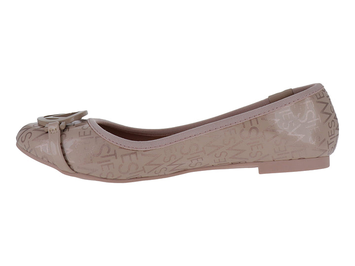 Zapato plano color nude con monograma grabado y adorno frontal circular.