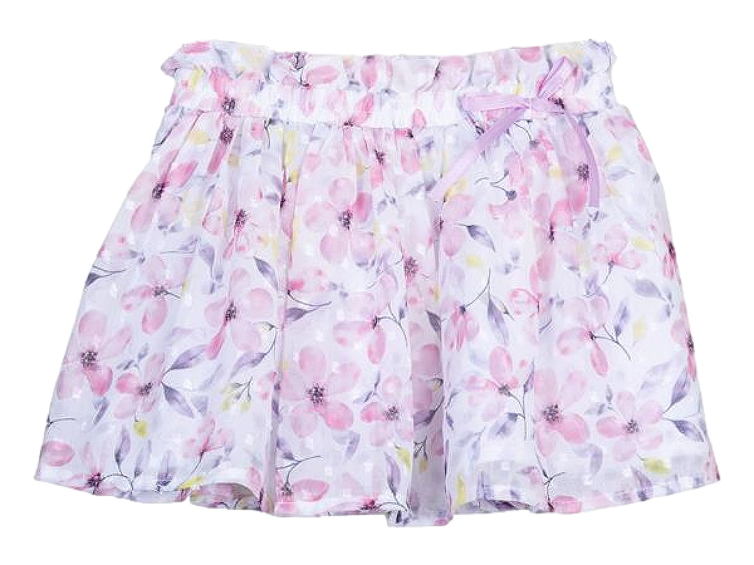 Falda blanca para niña con estampado de flores rosas y moradas y un lazo decorativo en la cintura.