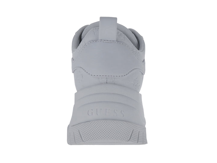 Tenis blancos de plataforma marca GUESS con suela gruesa y detalles en relieve sobre el material.