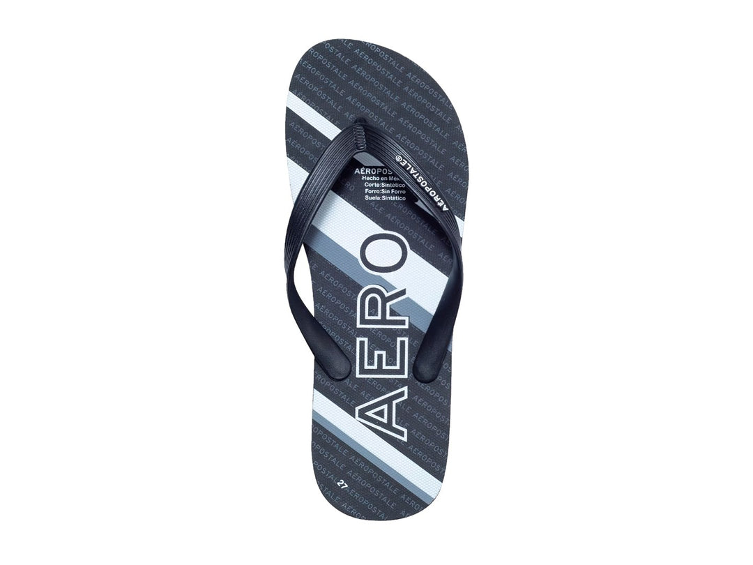 Sandalias negras y blancas de la marca Aeropostale con diseño de rayas y letras repetidas en la plantilla.