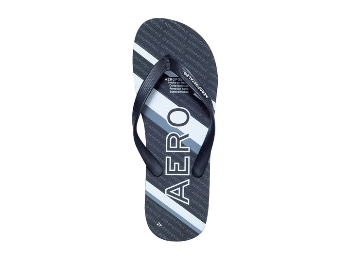 Sandalias negras y blancas de la marca Aeropostale con diseño de rayas y letras repetidas en la plantilla.