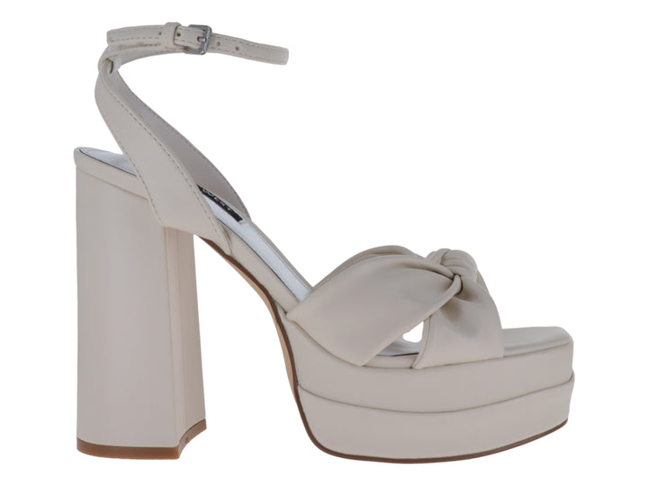 Sandalias Nine West color ivory con plataforma, tacón grueso y detalle de nudo decorativo en la parte frontal.
