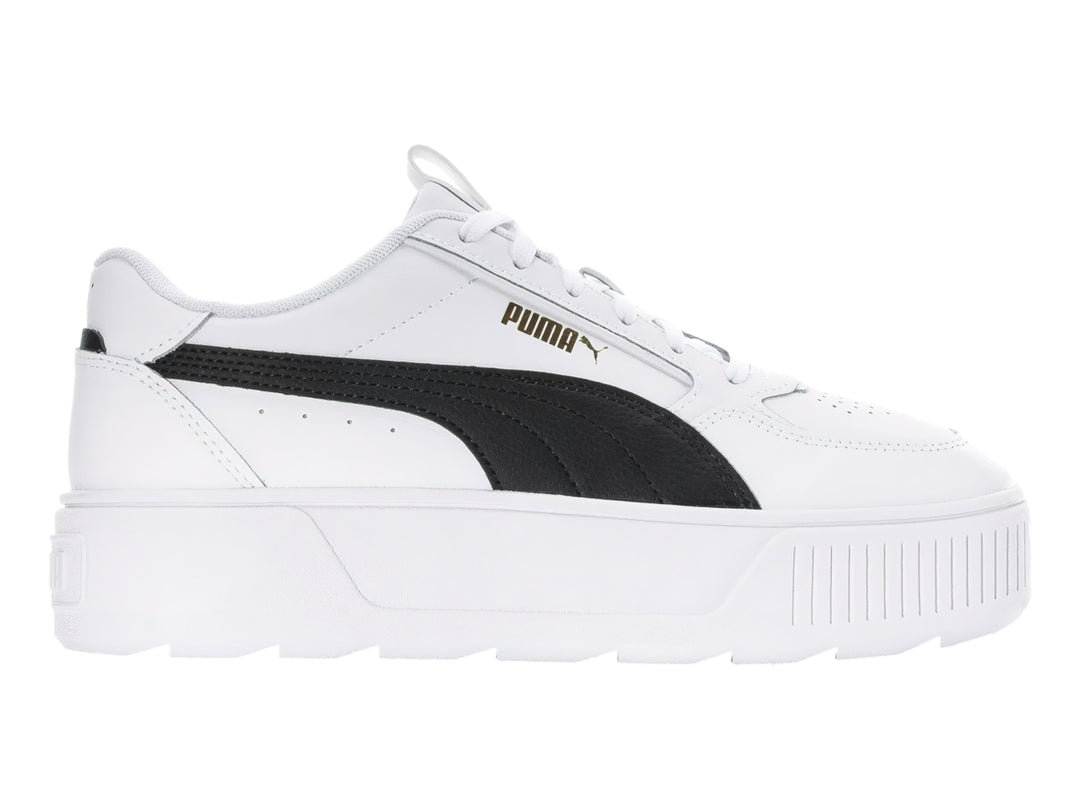 Tenis PUMA blancos con franja negra lateral y suela de plataforma blanca.